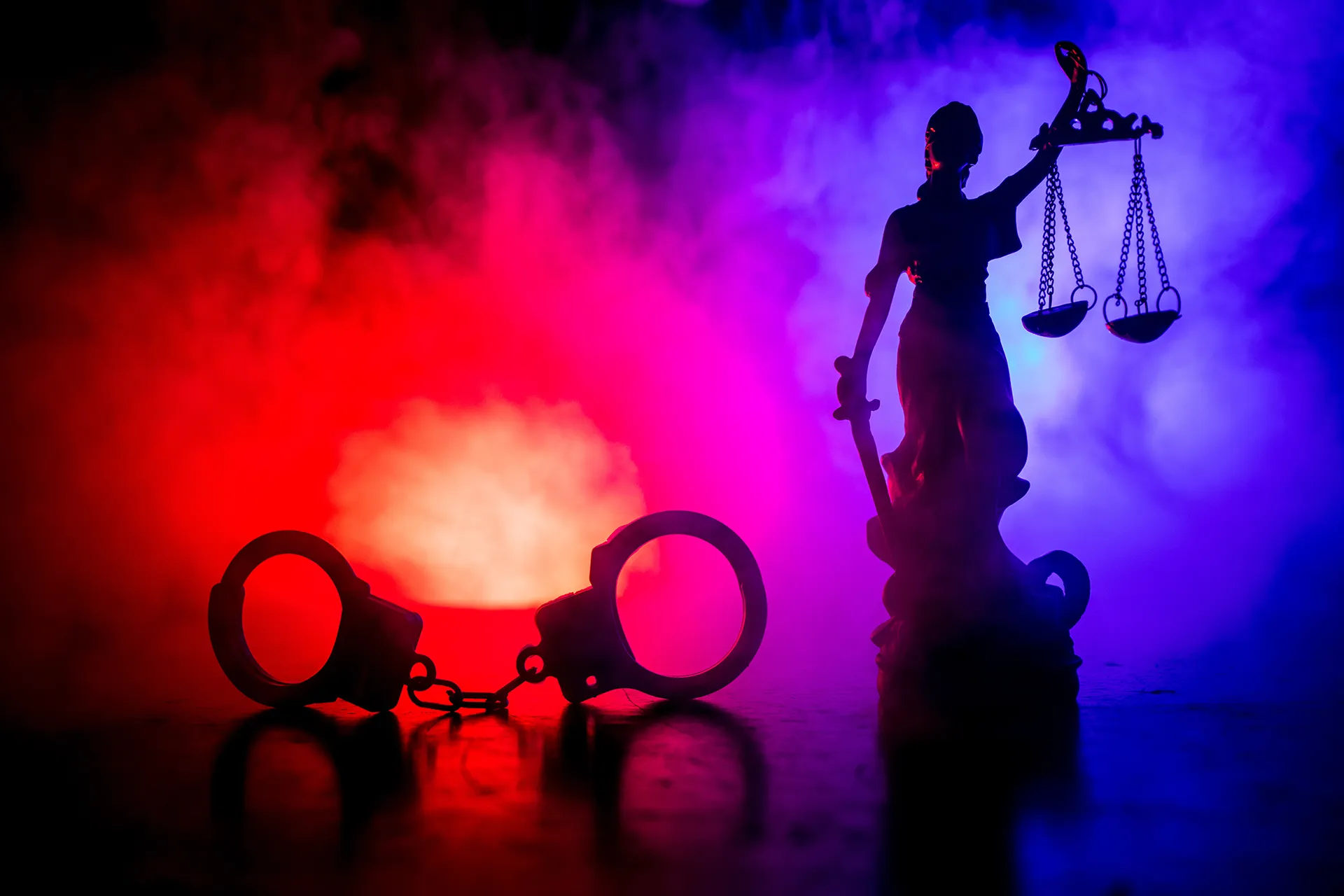 Scales of justice with handcuffs